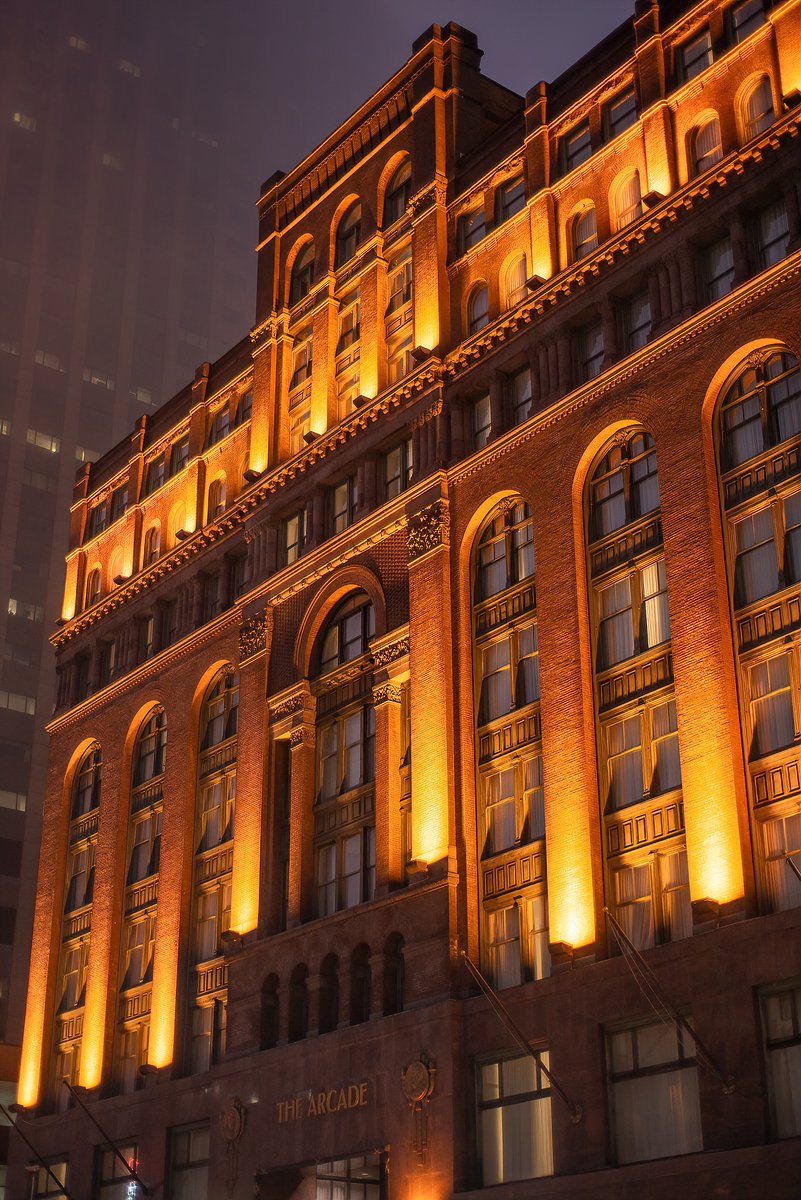 The facade of the Cleveland Arcade on Euclid Avenue in Cleveland, Ohio on a foggy winter's night. A little something different of an explore; this is considered one of the oldest original shopping malls in the country; a multi-leveled Victorian beauty opened in 1890!