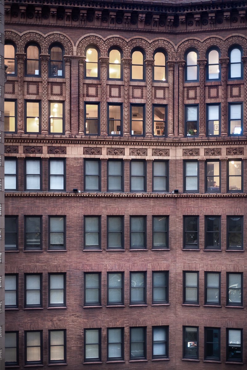 Life in microcosm; behind every set of four windows, someone's life story is playing out. An apartment building near Euclid Avenue in Cleveland, Ohio (January 2024).