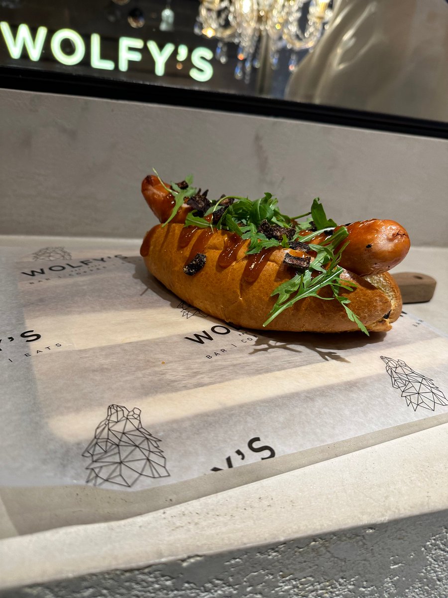 Satisfy your cravings with the bestselling Currywurst Dog at Wolfy's Bar! Indulge in a German cheese frankfurter smothered in currywurst sauce and onion flakes, all hugged by a brioche bun. #GermanFood #FoodieFaves #SatisfyYourCravings linktr.ee/wolfysbar