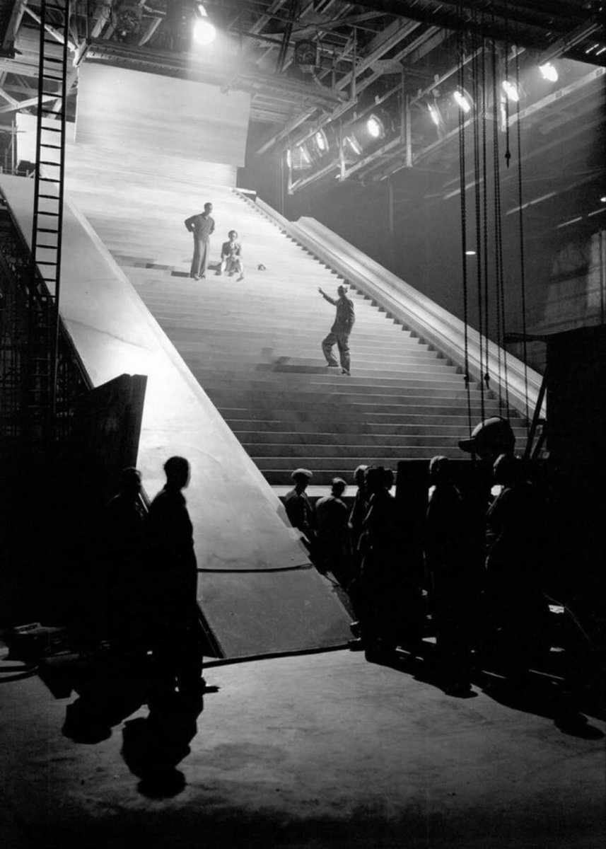 Director Michael Powell gives direction to David Niven and Marius on the staircase to heaven sequence on the set of A Matter Of Life And Death 1946. BBC 2 1pm today.