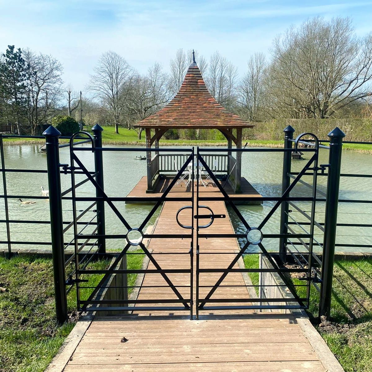 Our handmade Quadrant gates leading down to the pontoon.  One of our latest installations in East Sussex. 
Small dog rods added to the bottom of the gate to stop dogs passing between the rails.

#pontoon
#fence
#steelfence
#steel
#gate
#thetraditionalco