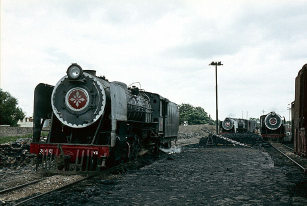 A beautiful photo showing three YG class steam locos at Guntur station, taken by Jan Von Dorp in the early 1980s! The early YG class locos were built by Lokomotivfabrik Floridsdorf, Austria, in the late 1940s and by TELCO and CLW since the early 1950s. <a href="/SachinKalbag/">Sachin Kalbag</a> <a href="/somnath1978/">Somnath Mukherjee</a>