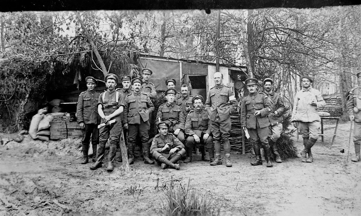 Incredible Carte Postale of a camouflaged hut (Dressing Station?) of the Royal Army Medical Corps in woodland in Northern France c.1917. Wellies, French Interpreters, and divisional insignia! Detail in the ALT. @thehistorygirl1 @Taff_Gillingham @ProfPeterDoyle