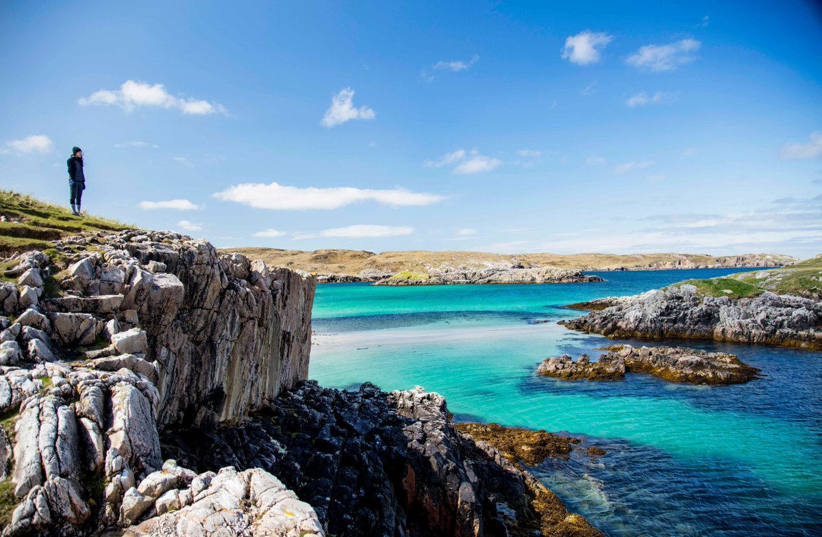 It it wasn't for the person wearing a coat, you'd be forgiven for mistaking this rugged landscape and turquoise water for a Greek island or the Italian Riveira. Nope, this is the Isle of Harris off the West Coast of Scotland #Holiday #NottinghamTravelAgent #HolidaysinScotland