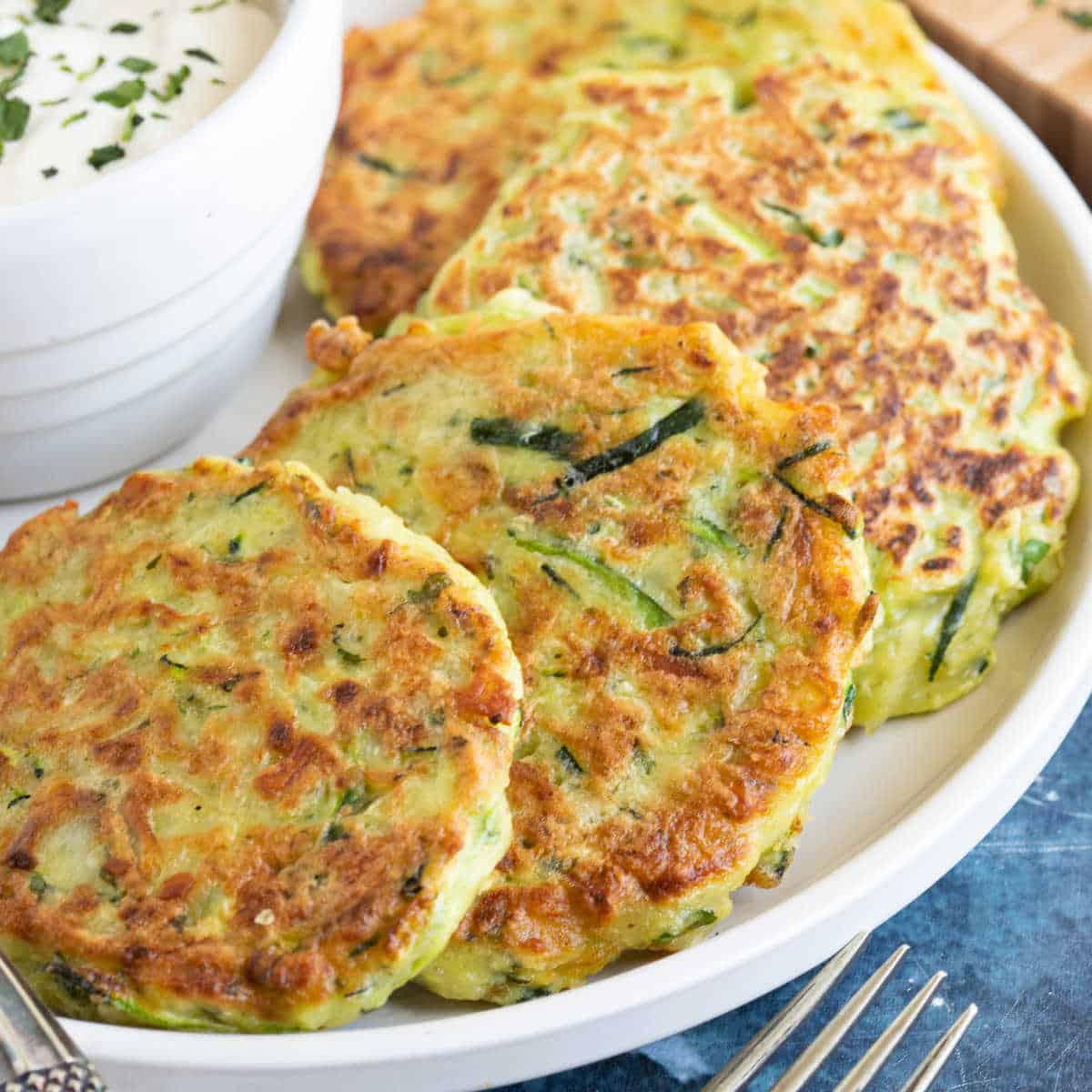 Cheesy courgette fritters are a great way of using up a glut of homegrown courgettes.

Get the recipe => bit.ly/33zhkTL