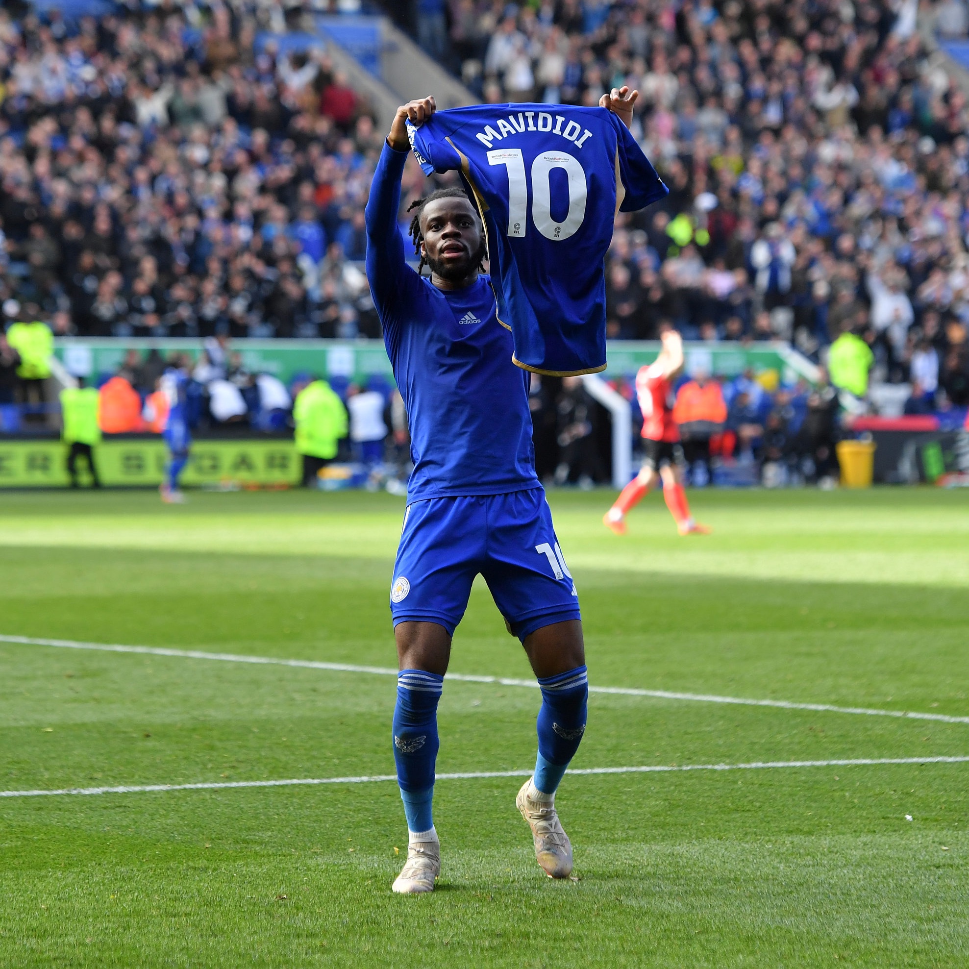 Stephy Mavididi holds up his shirt.