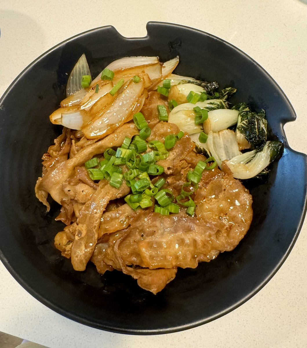 Thin sliced marinated pork belly with baby bok and onions over rice 😋