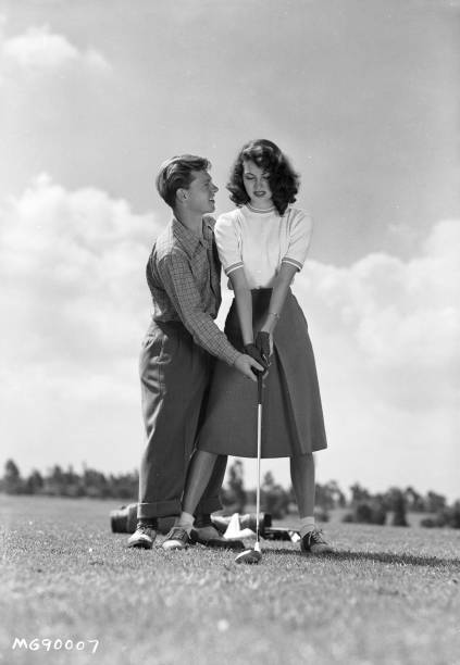 Mickey Rooney helps Ava Gardner with her golfing in 1942, the year they married.