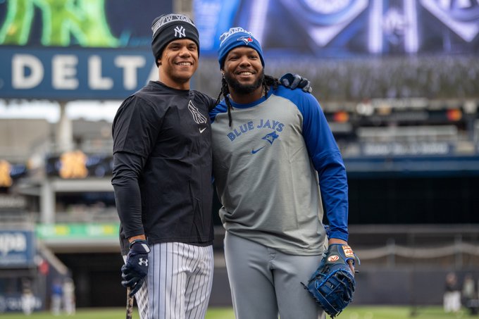 A photo of Juan Soto with his arm around Vladimir Guerrero Jr. at Yankee Stadium during batting practice.
