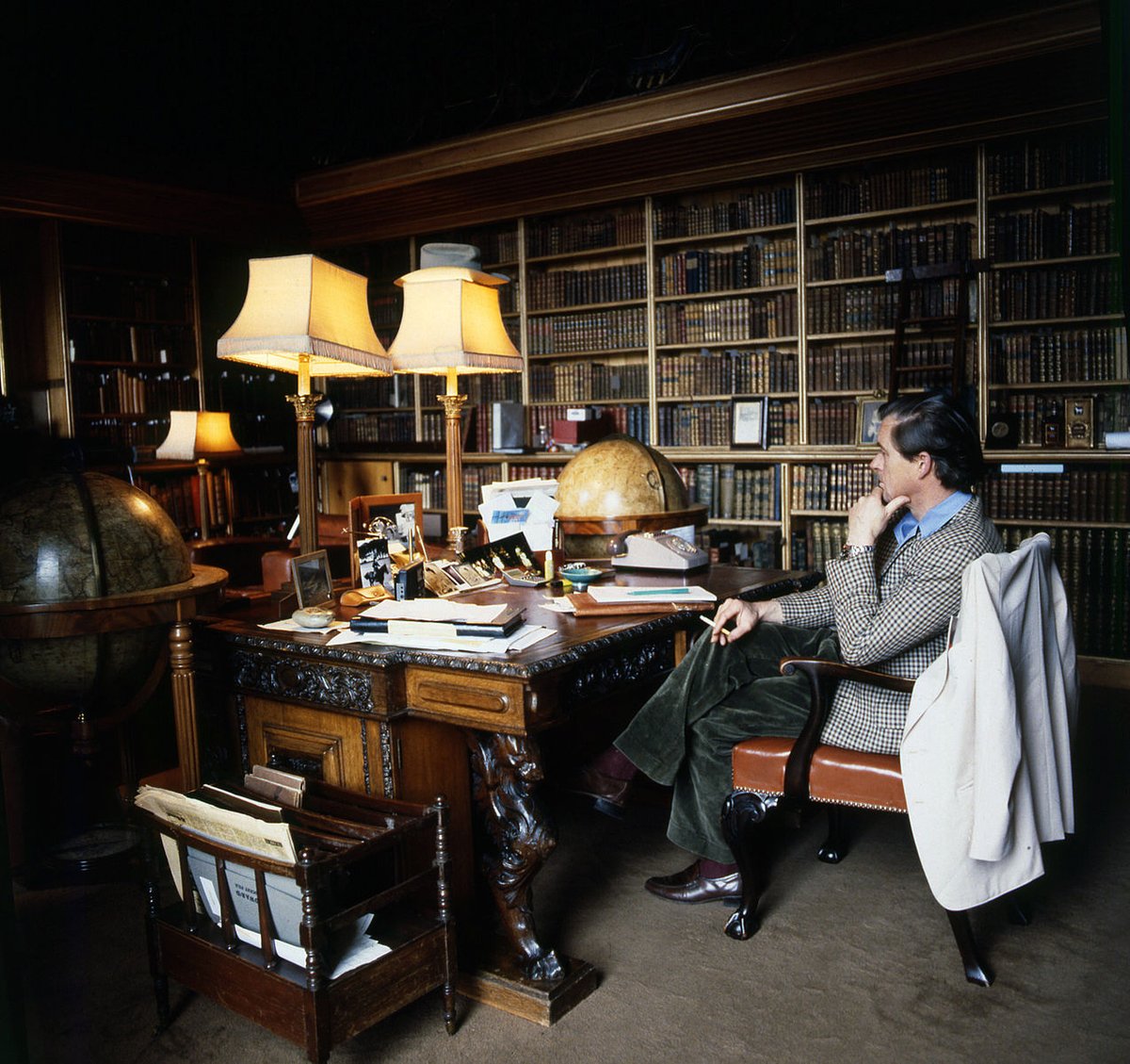 By contrast, here we see Ian Campbell, 12th Duke of Argyll, wearing more casual attire: brown checked tweed sport coat, corduroy trousers, light blue shirt, and brown loafers. Everything here says country: checks, tweeds, corduroy, blue, green, and brown