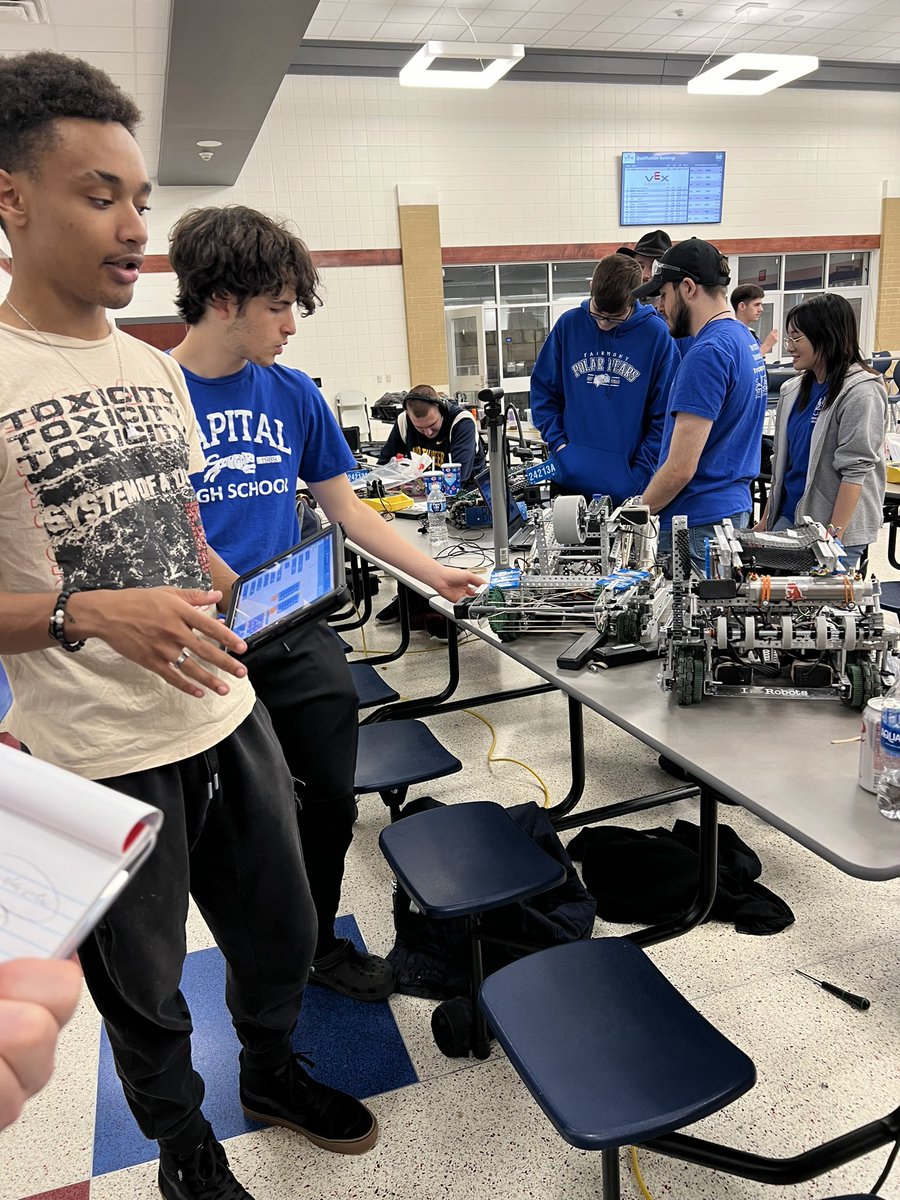 Members of Capital High School discuss the unique design and coding of their robot