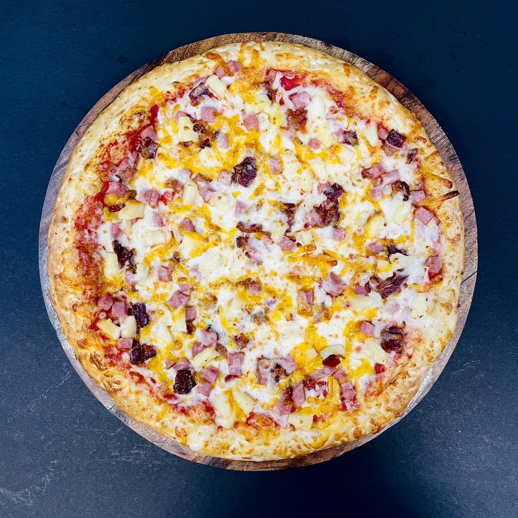Hawaiian Pizza! 🍍🍕 Indulge in the perfect blend of sweet pineapple, savory ham, and gooey cheese. It’s a taste of tropical bliss in every bite! #HawaiianPizza #PizzaPerfection