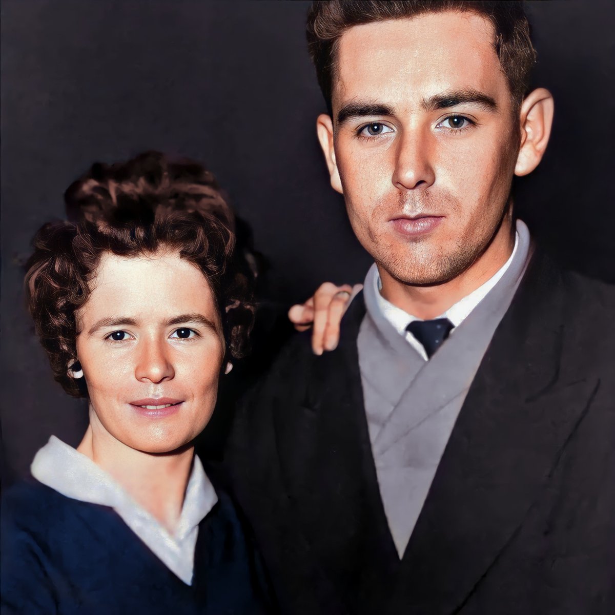 c.1960, Betty & Paddy Betty Walsh (née Hannigan) stands beside Paddy Walsh in their engagement photo. Hopeful gazes, snappy attire capture the beginning of a lifetime together. My Aunt Betty sadly passed earlier this year. RIP. 📷 Private Collection #Waterford #Colourised