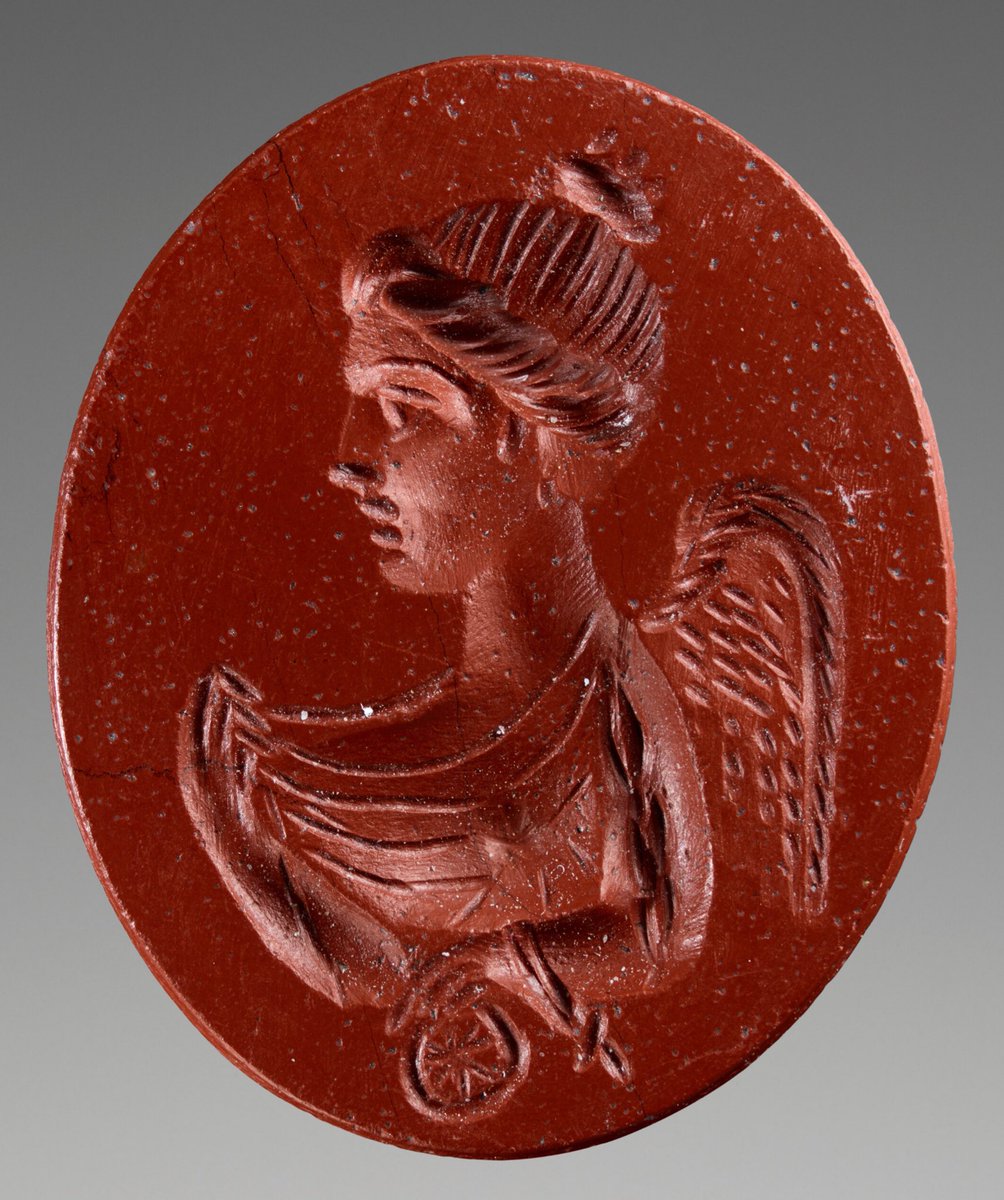 Engraved Gem depicting the goddess Nemesis ~ c. C2nd CE This engraved red jasper is small (only 1.7cm in length!) but the detail of the portrait is phenomenal. The winged goddess Nemesis holds a wheel in her right hand symbolising fate and its power. 🏛 The Getty