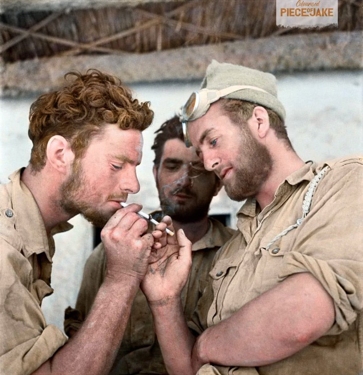 Members of Y-Patrol of the Long-Range Desert Group, British Army, take a smoke break after returning to headquarters following a reconnaissance mission during the North African Campaign. Photograph taken at Siwa Oasis, Western Desert, Egypt, in 1942.