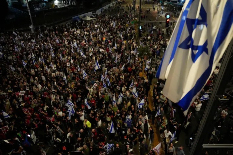 'In Tel Aviv, Israelis rally for Netanyahu's resignation amid protests on the 6-month anniversary of a Hamas attack. Clashes with police and arrests reported. Protesters wave flags and demand freedom from Netanyahu's leadership. #IsraelProtests #NetanyahuResign 🇮🇱'