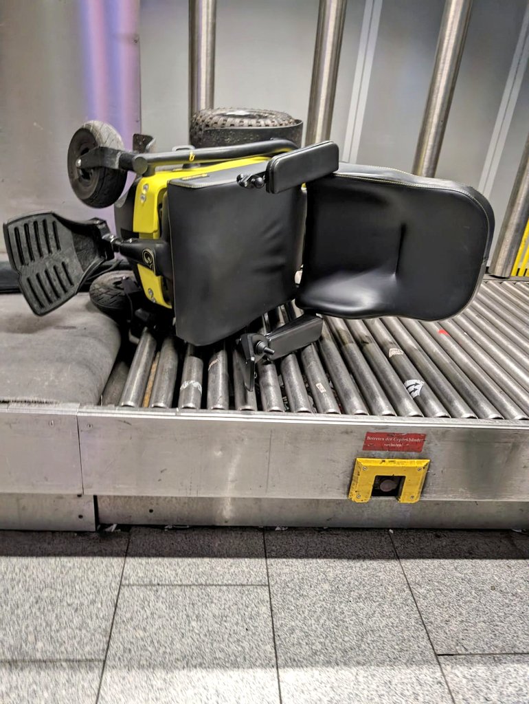 My husband Alex @FreedomOneLife arrived @Airport_FRA to find his powerchair like this. Thankfully he deliberately designed the chair to be robust for air travel & the chair is fine but no one should be greeted by this scene. #rightsOnFlights #DisabilityTwitter