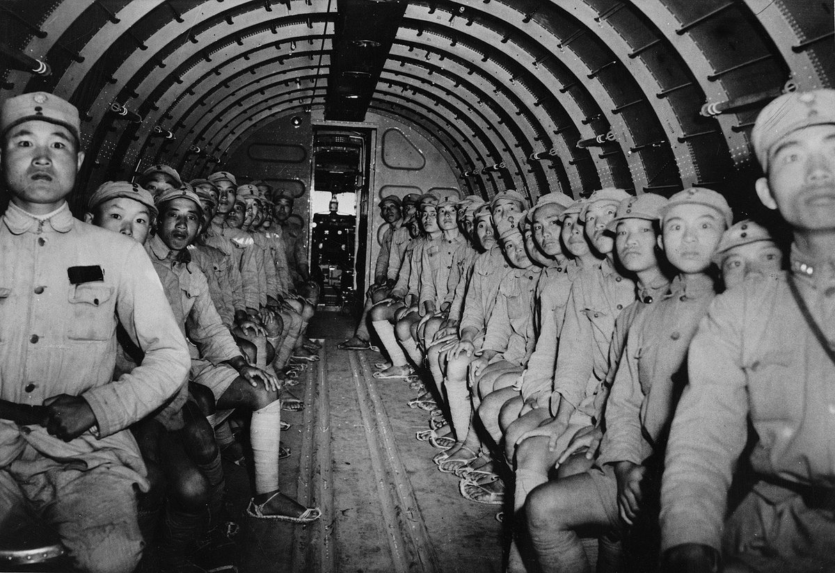 Chinese soldiers onboard DC3, flying over Himalaya, to U.S. Ramgarh Training Center in India, 1943. They wearing straw sandals, later went to Burma to fight against the Japanese army, and most of them died on the battlefield.