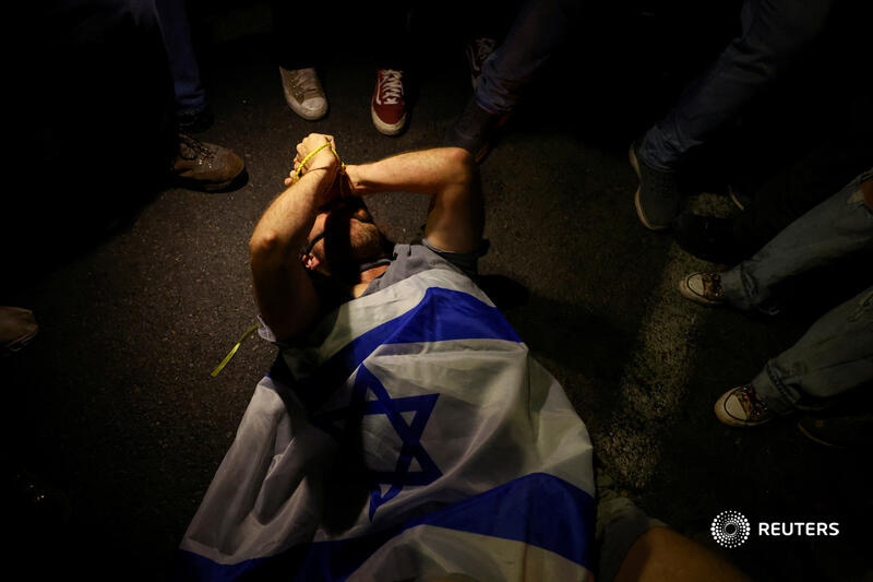 A demonstrator with his hands tied lies on the ground during a protest in Tel Aviv, Israel, against Prime Minister Benjamin Netanyahu's government and calling for the release of kidnapped hostages. More photos of the week: reut.rs/3vxXc6e 📷 Hannah McKay