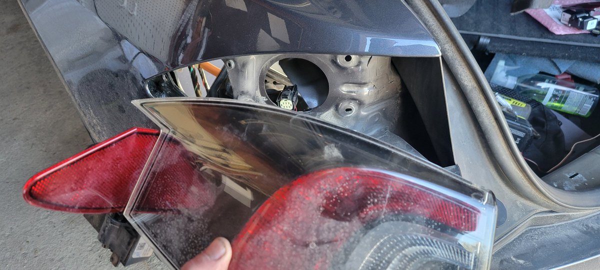 levismith's tweet image. Ah, current 9yr old 351K mile Tesla project. Replace the door for the charge port which has been randomly opening on its own. Likely failed because a drain was clogged. Biggest issue is that a nut inside the body didn't stay welded (spin, spin!) so out came the drill.