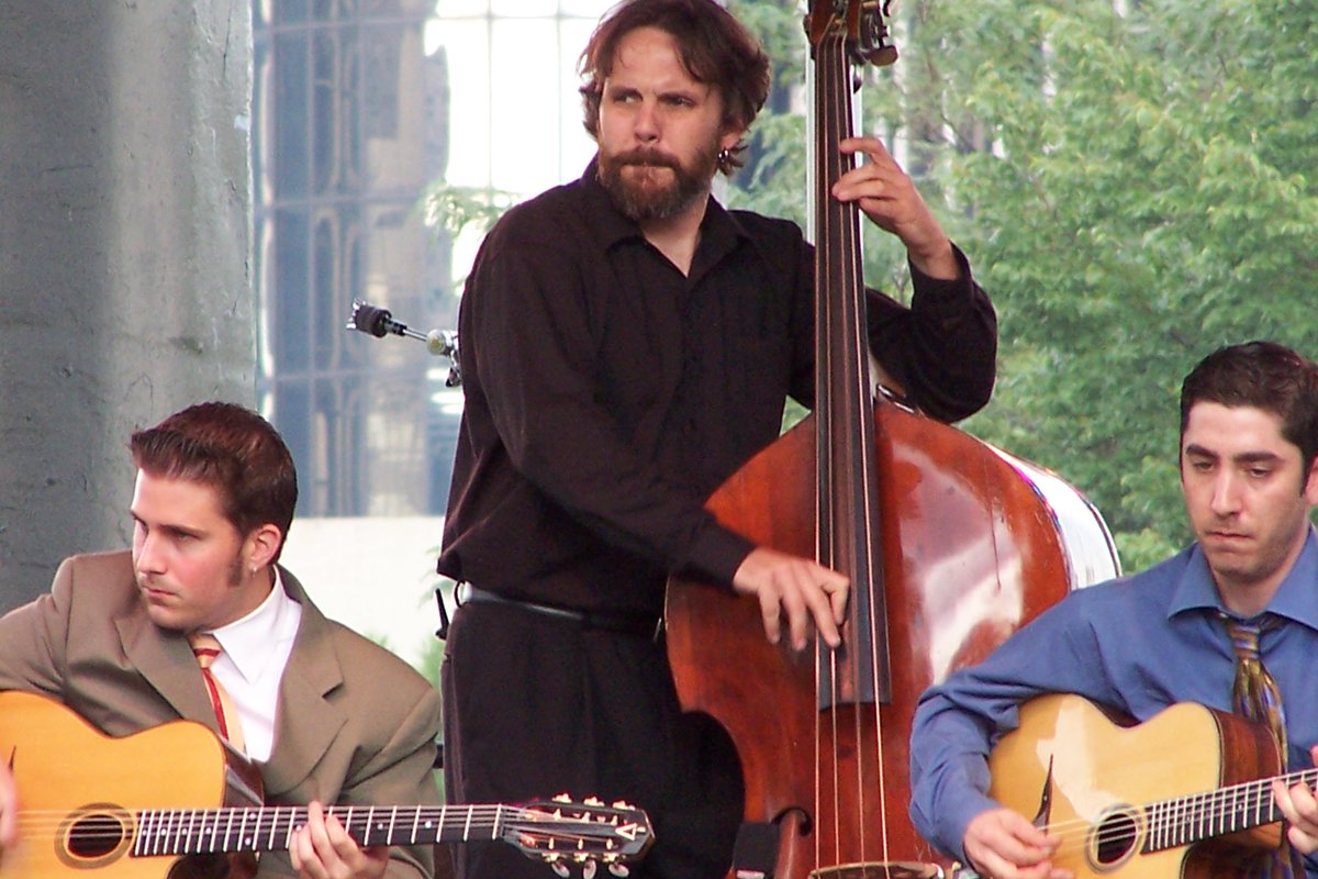 As we count down to the 45th Detroit Jazz Festival, enjoy this #TBT from 2006 and photographer Jeff Dunn – the Hot Club of Detroit, playing gypsy jazz on a festival stage, with the RenCen rising behind them.