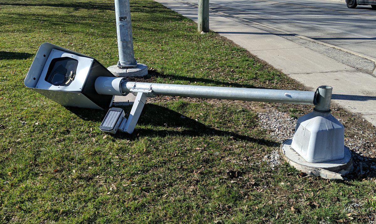 This morning on Victoria Ave in Vineland. Niagara, Ontario.   Someone used a cordless grinder to cut the bottom of the post on this Speed camera. 
How unfortunate!  
What an efficient piece of equipment.