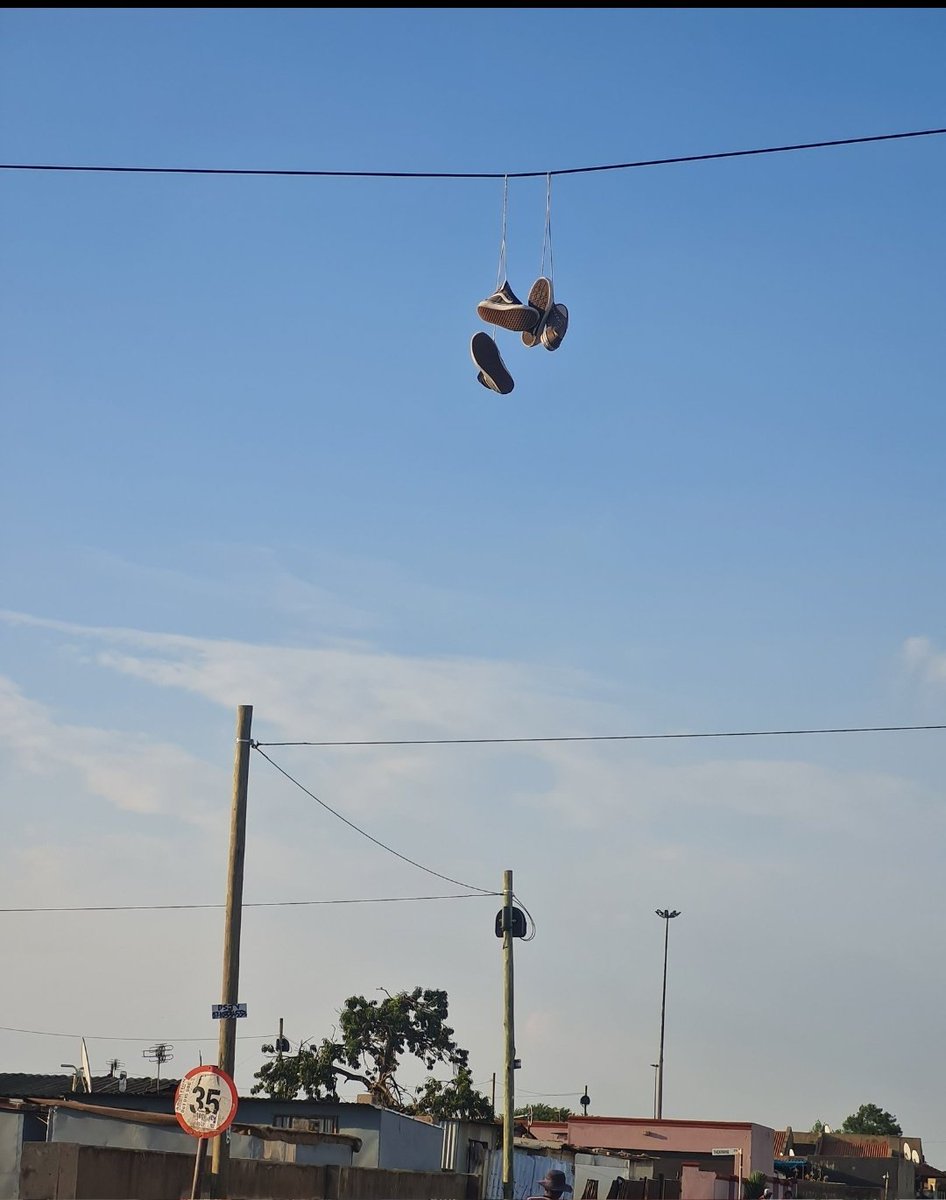 gnont's tweet photo. What is the purpose of those sneakers attached to the power lines? https://t.co/y2l20DsDgv