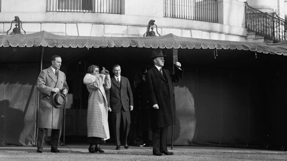 At White House, Grace and Calvin Coolidge watch solar eclipse through dark protective filters, 1925: