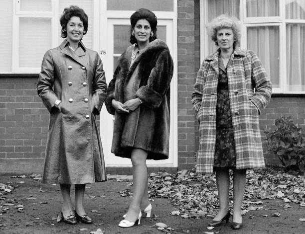 Three women photographed in Manchester wearing their winter coats, 1970. Photo by Sefton Samuels.