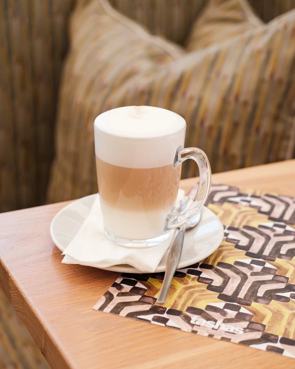 As the crisp autumn air sets in and leaves paint the city in shades of gold, there's no better way to cosy up and embrace the season's charm than with a steaming cup of caffe latte from @tashascafe. ☕️🍂 #TheZoneRosebank #OnlyAtTheZone #Tashas