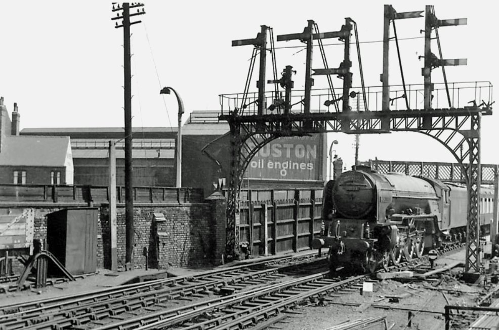 Mainline diverted train with A1 60123 'H A Ivatt' passing under an impressive signal gantry at Lincoln in the late 50s early 60s. Photo by Ray Heppenstall