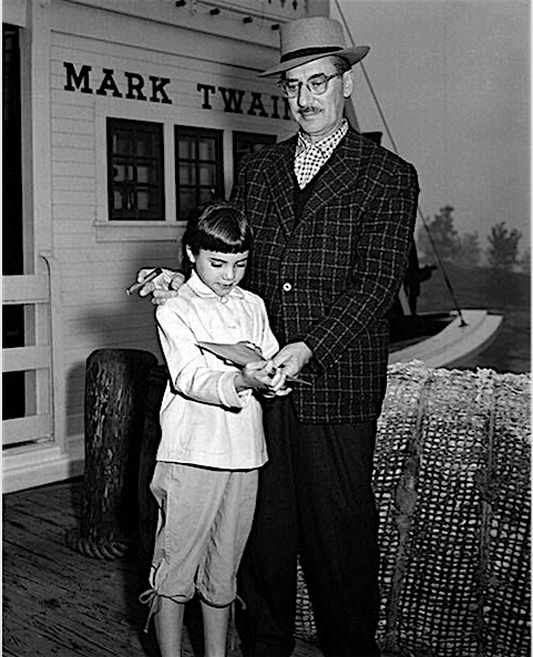 Groucho and nine-year-old Melinda on the loading dock of the 'Mark Twain' riverboat at Disneyland in the Fall of 1955, only weeks after the famous amusement park opened.