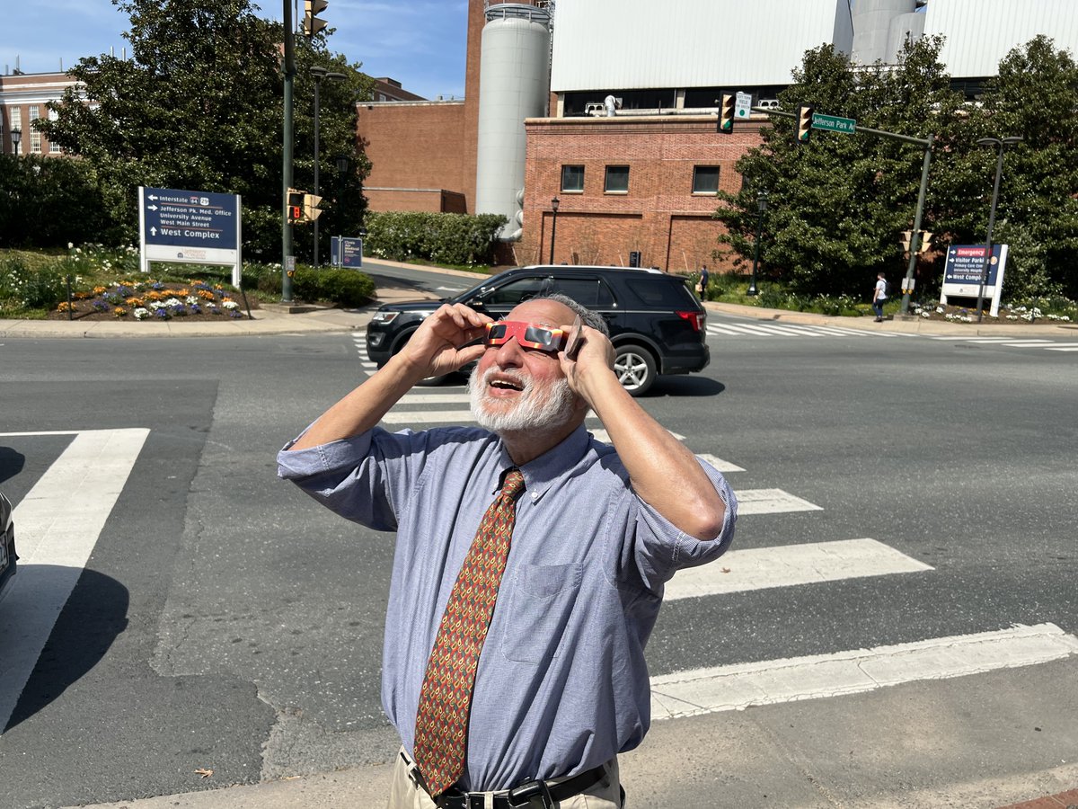 Dr. Lobo taking a break to view the partial (86%) eclipse in Charlottesville. @NephTushar @UVANeph @Virginia_KUH