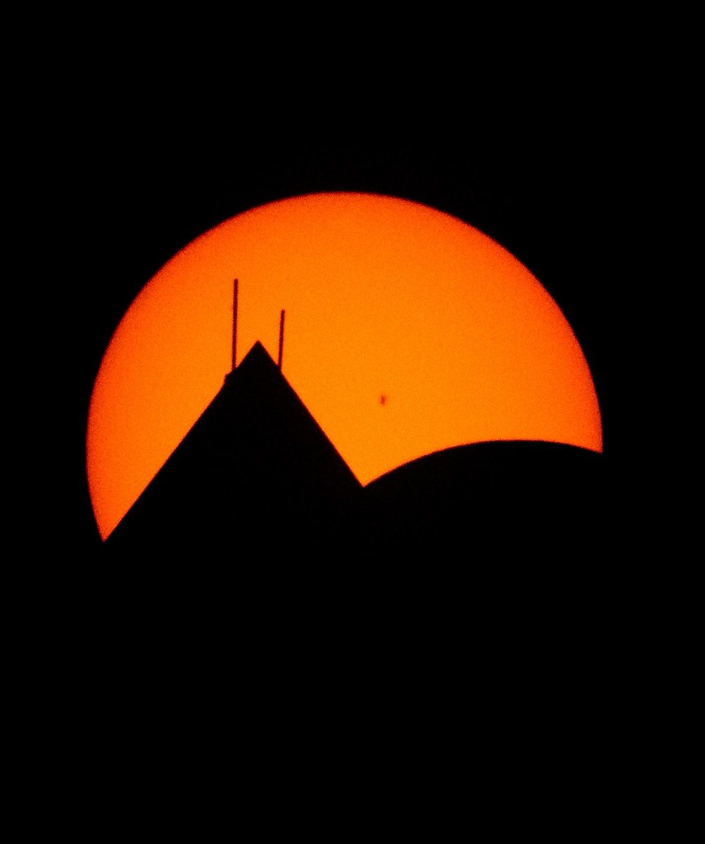 The Moon, lower right, is seen passing in front of the Sun, with the top of the Washington Monument in silhouette, during a partial solar eclipse in Washington DC Photo Credit: (NASA/ @ingallsimages