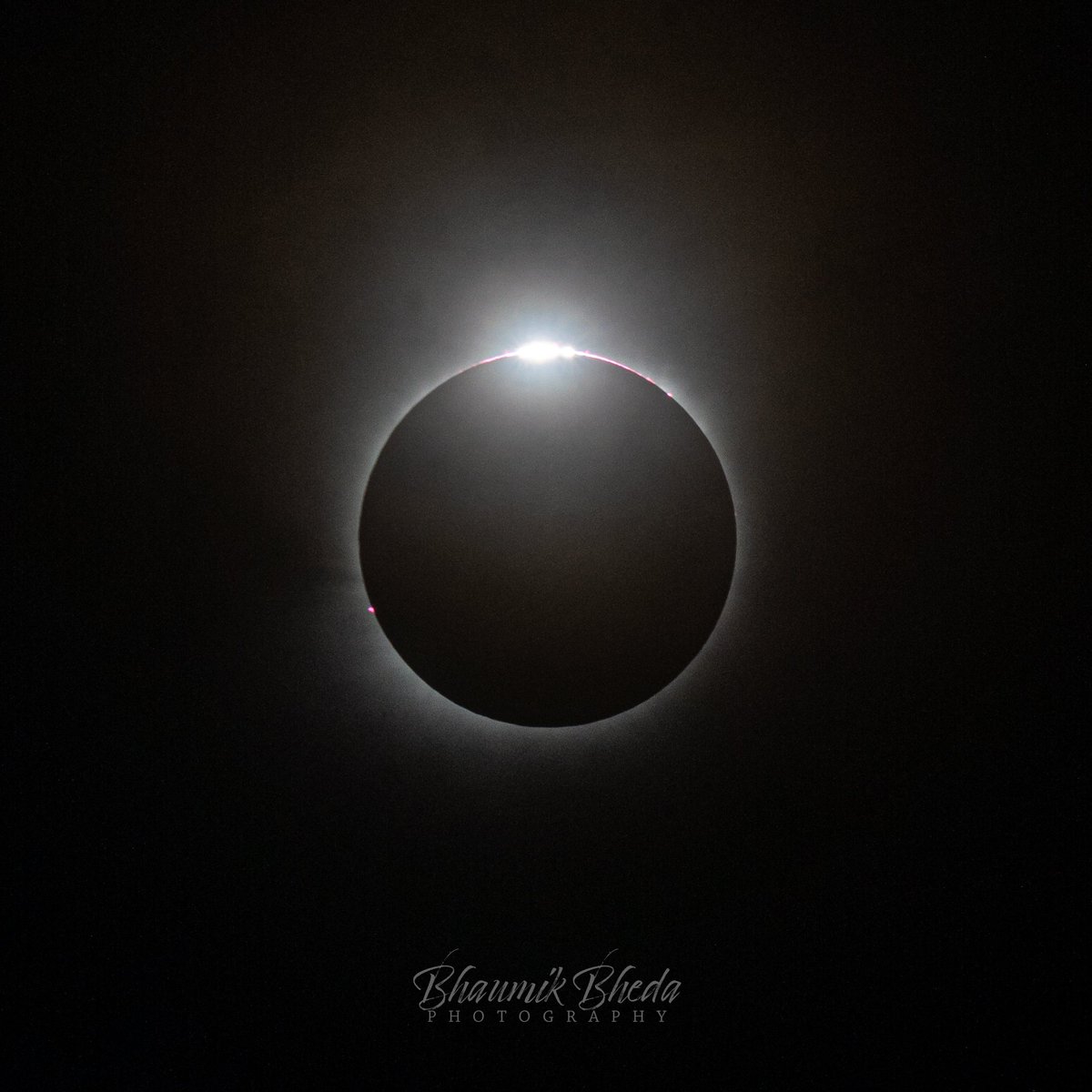 Diamond Ring Effect: a fleeting glimpse of cosmic majesty, through a cloudy sky, as the sun's corona peeks through the moon's silhouette, casting its ethereal glow over Austin, Texas. #SolarEclipse #CelestialSplendor 🌑💍