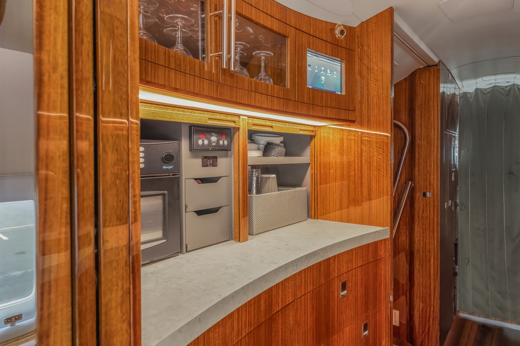 Bask in the warm embrace of the most immaculate galley in the sky, where honey-colored wood shines in all its glory. 
#AircraftPhotography #REMediaPhotos #AviationPhotographer #HoneyHuedHeavens #GalleyGrace #CraftsmanshipInClouds #AeroMedia #aircraftphotog