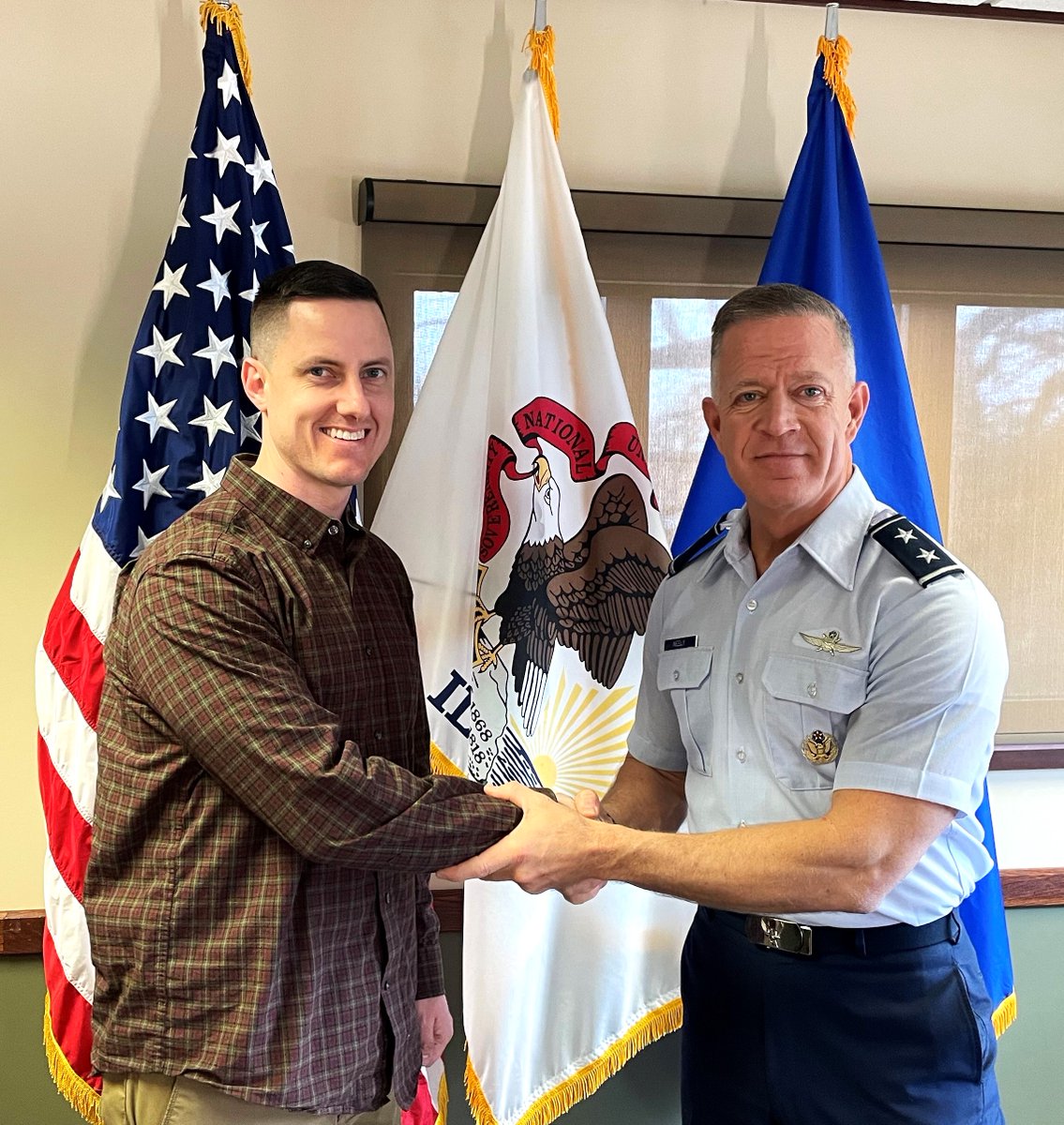 Maj. Gen. Rich Neely, the Commander of the Illinois National Guard, presented Bobby Adams with his command coin, April 5. Adams, a civilian in the public affairs office and an E-7 in the 139th MPAD, produced many high-profile video and photo projects during Neely's command.