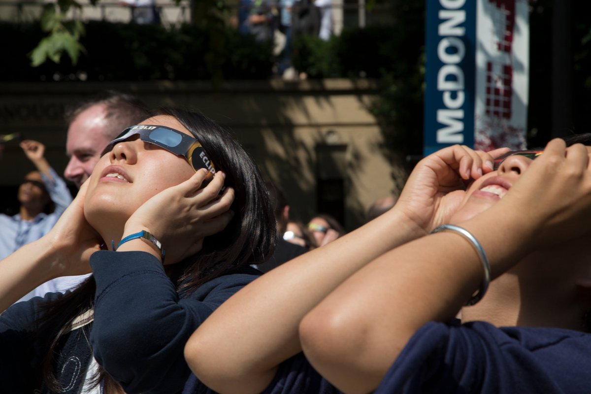 In less than an hour, D.C. hits peak partial #eclipse at 3:20 PM ET! We hope you'll grab your ISO 12312-2 eclipse glasses to witness this extraordinary event! 🌒 Until then, check out these throwback photos from Georgetown Law's last eclipse gathering on 8/21/2017! #Eclipse2024