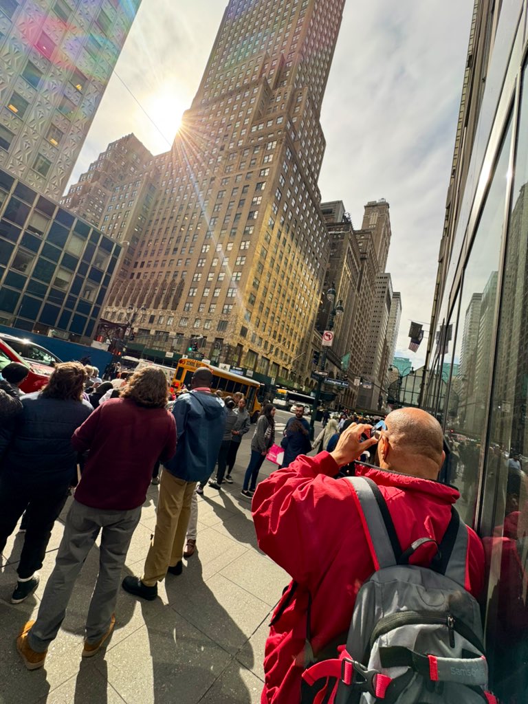 Love the vibe in New York this afternoon — at the corner of 42nd and Lex, where there is a sliver of sunlight between the buildings, people are glimpsing the eclipse, then handing their glasses to strangers so everyone can see