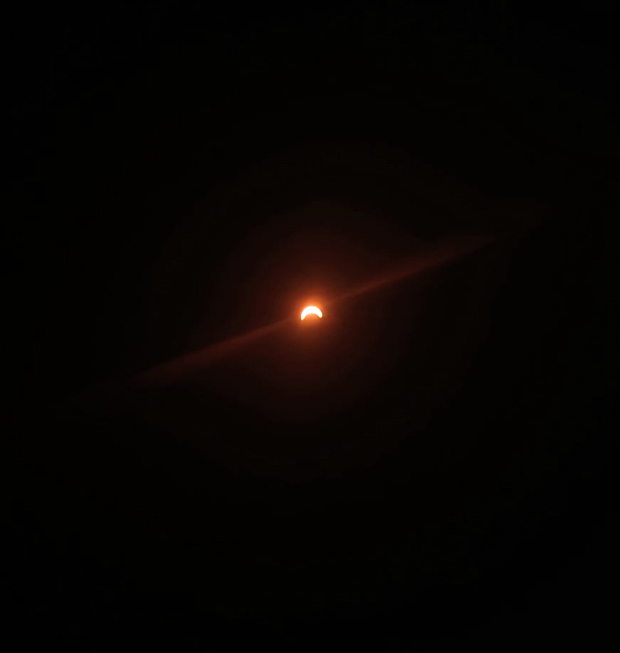 Eclipse here in Maine on a Google Pixel phone with eclipse glasses as a filter over the lens. We also noticed a pulsing effect of light on the ground around us as 99% coverage approached which was crazy. 🤯