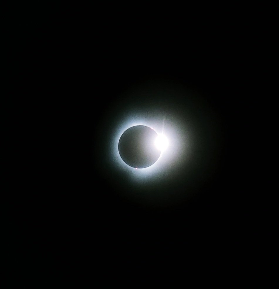 Total eclipse at 3:12pm in Toledo, OH. This is the best I could do with the phone camera + eclipse sun glasses but wow that was a cool experience. #Eclipse2024