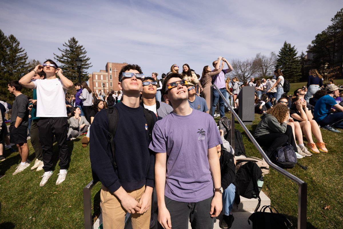 Students, staff, and faculty enjoying the celestial phenomena (and weather) today ☀️🌑 😎 #solareclipse #holycross