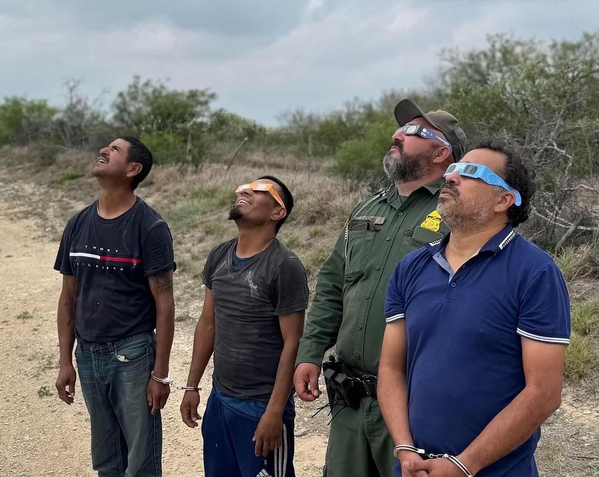 Illegal aliens and Border Patrol agents enjoying the solar eclipse together