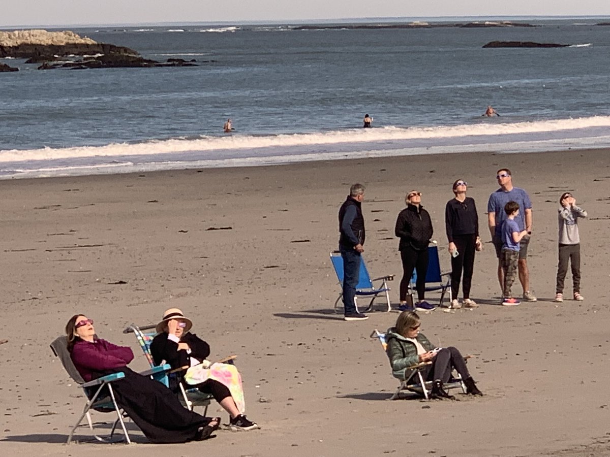 SUBMERGED FTW: A few spectators chose to experience the eclipse Monday in the cool, shallow waters off Sandy Beach in Cohasset, Massachusetts.