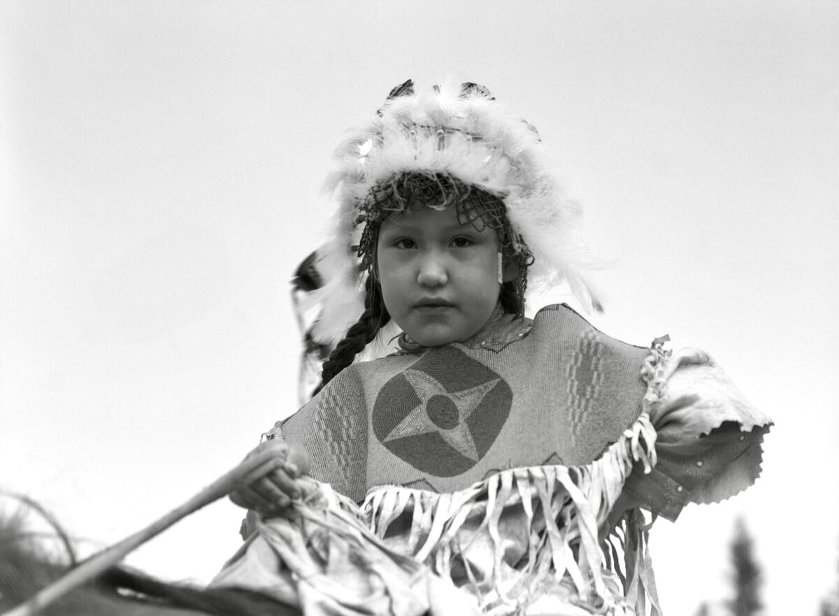 Stoney Nakoda girl on horseback. Possibly photographed at Banff Indian Days. No specific year, but likely 1930s. (so far, unidentified). 📷 Dan McCowan | Glenbow. University of Calgary Digital Collections