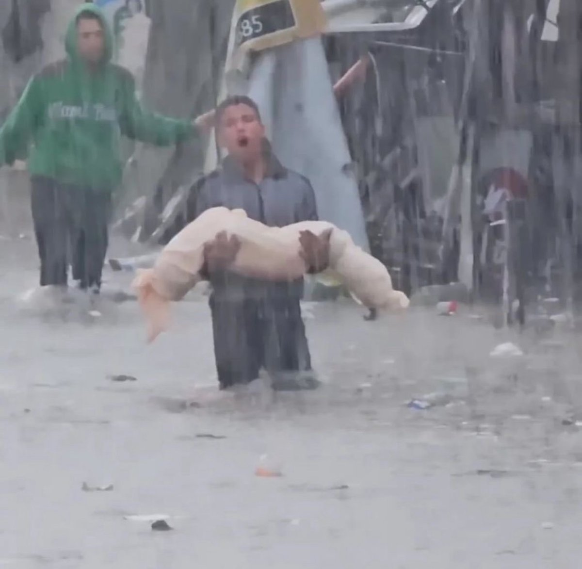THE WORLD WATCHED THIS PALESTINIAN BOY CARRYING THE CORPSE OF A CHILD IN THE RAIN This did not impact the World.