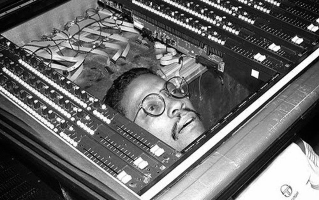 Herbie Hancock trying to figure out how to fix a mixer, c. early 80s.