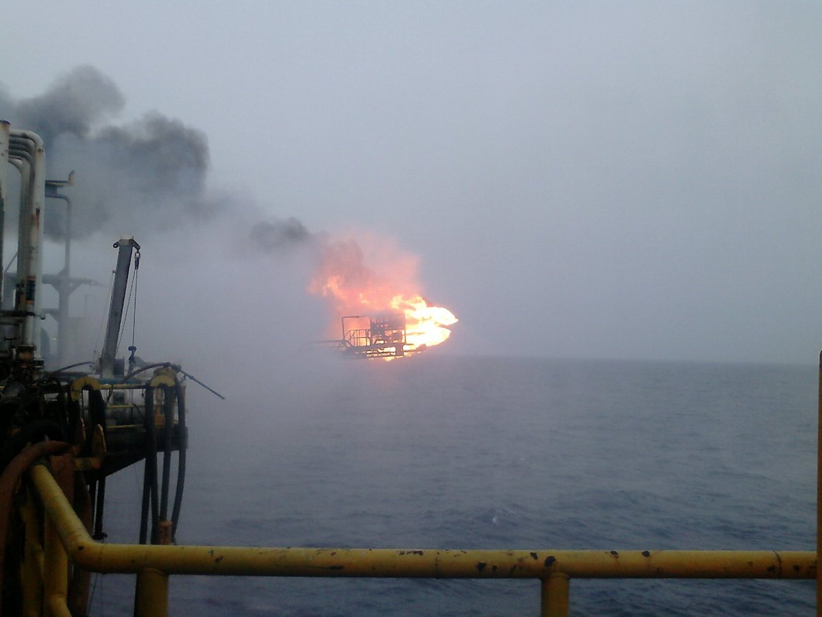 This is an actual picture from my first job after college. I was an oil and gas engineer for Schlumberger, working on oil rigs and testing oil wells

Life arcs can be unpredictable :) 

PS The flame is completely normal (oil rigs burn excess oil during testing via a burner)