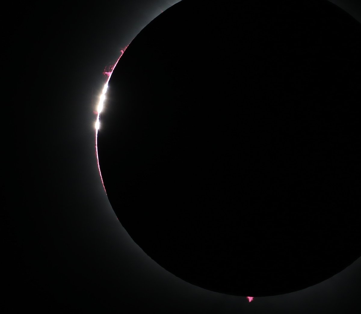 Luckily, the clouds parted in East Texas, and we were rewarded with a total solar eclipse. In this view, Baily's Beads and arcs of plasma spill out around the limb of the Moon.