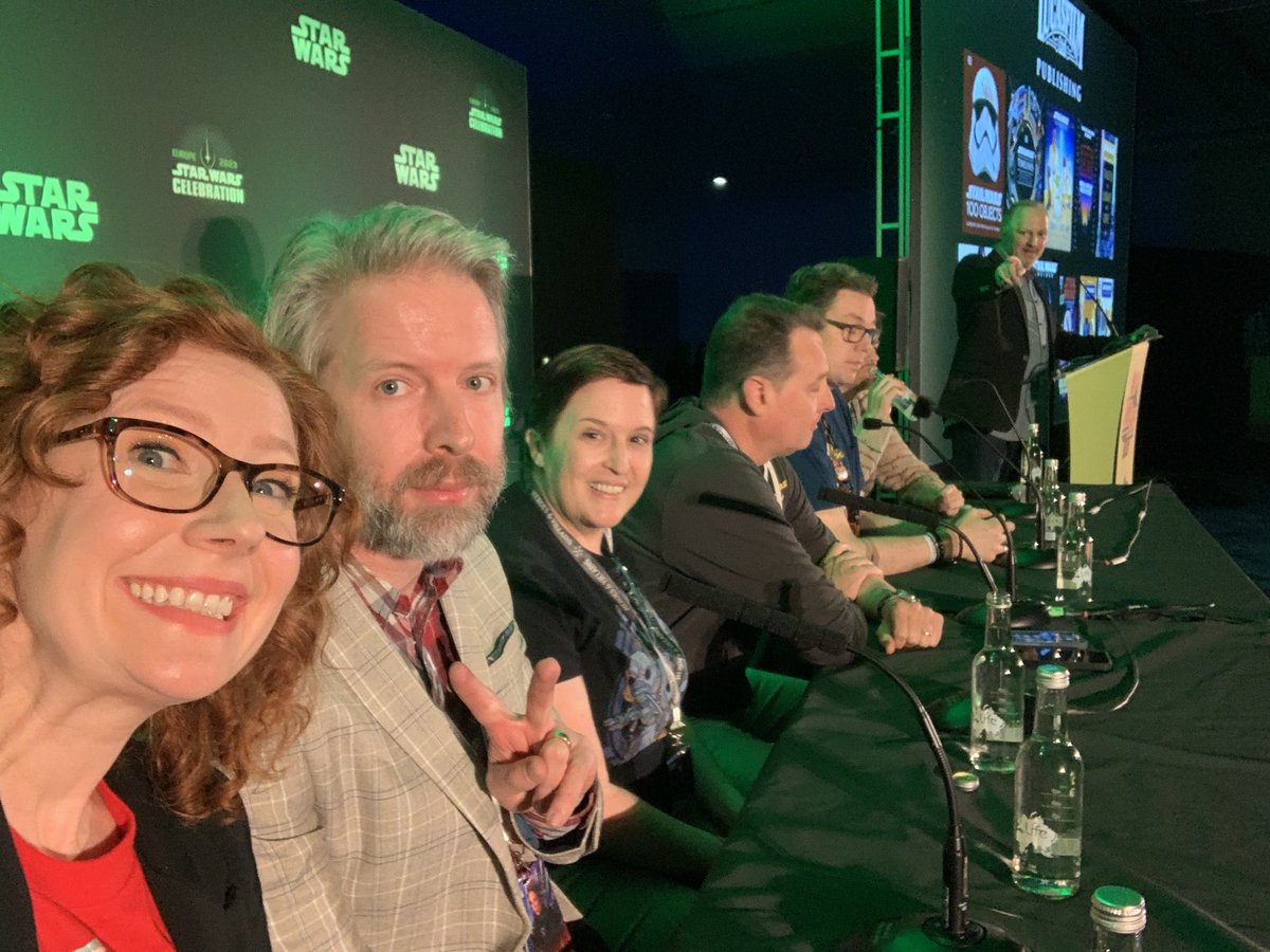 Happy 1-year anniversary to me and @KristinBaver getting busted by @msiglain on the #StarWarsCelebration London LFL publishing panel just as we were taking a selfie. Yes, Mike is pointing at us. Oops. Also featuring @amyrichau, @Clayton_Sandell, Cavan Scott, @CharlesSoule's arm.